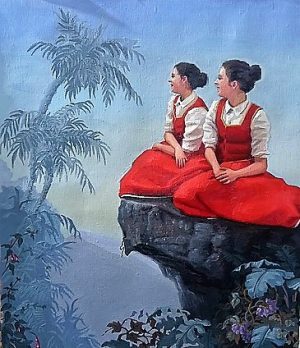 Twee jonge vrouwen in rode traditionele jurken zitten op een rots en kijken verwachtingsvol uit.
