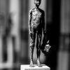 Grootbrengen - bronzen beeld van een naakte jongen met een vogel, gemaakt door Heleen Kater.
