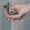Close-up of the compass in the hands of a girl. En route is an oilpainting by Gabriëlle Westra
