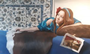 Oilpainting by Gabriëlle Westra. A girl with red long hair and a rose in it lies on a sofa on a cowhide. She weares a blue dress. On the wall a blue grey ornamental wall covering. It is an ode to Sir Alma Tadema's cherries.